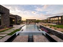 Luxury backyard oasis with a large pool and waterfall feature at 8332 E Sand Flower Dr # 20, Scottsdale, AZ 85266