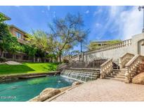 Scenic waterway with a cascading waterfall and lush landscaping at 2989 N 44Th St # 3036, Phoenix, AZ 85018