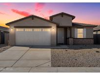 Two-story house with a two-car garage, landscaping, and a light-colored exterior at 37287 W Patterson St, Maricopa, AZ 85138