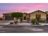 Beautiful home exterior with stone accents and landscaping at 21062 N 76Th Ave, Glendale, AZ 85308