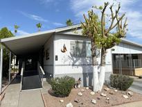 Single-wide manufactured home with carport and landscaping at 4065 E University Dr # 462, Mesa, AZ 85205