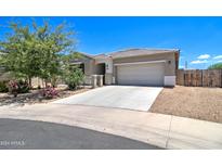 Single story home with a two-car garage and well-manicured landscaping at 19731 N Ben Ct, Maricopa, AZ 85138