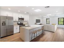 Modern kitchen with island, stainless steel appliances, and white cabinets at 16844 E Ave Of The Fountains -- # 201, Fountain Hills, AZ 85268