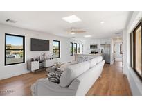 Open living space with hardwood floors, modern kitchen, and large windows at 16844 E Ave Of The Fountains -- # 202, Fountain Hills, AZ 85268