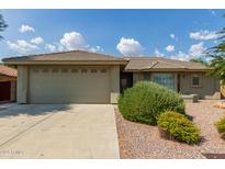 House exterior showcasing a two-car garage and attractive landscaping at 10908 E Olla Ave, Mesa, AZ 85212