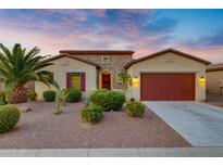 Beautiful desert-style home with red garage door at 41650 W Harvest Moon Dr, Maricopa, AZ 85138