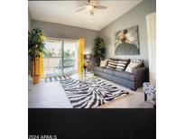 Bright living room with zebra rug and balcony access at 7101 W Beardsley Rd # 452, Glendale, AZ 85308