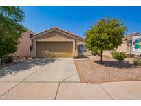 One-story house with a beige stucco exterior, double-car garage, and small front yard at 23780 W Tonto St, Buckeye, AZ 85326