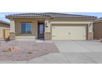 House exterior with a two-car garage and stone accents at 10347 N 115Th Ave, Youngtown, AZ 85363