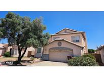 Two-story house with attached garage and mature tree at 16549 N 91St Dr, Peoria, AZ 85382