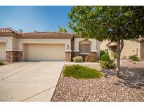 Well-maintained home exterior with two car garage and landscaping at 1560 E Melrose Dr, Casa Grande, AZ 85122