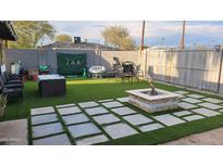 Cozy backyard with fire pit and artificial turf at 5753 N 31St Ln, Phoenix, AZ 85017