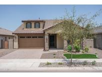 One-story home with a brown garage door and stone accents at 16172 W Alameda Rd, Surprise, AZ 85387