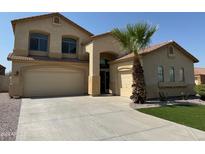 Two-story house with a tan exterior and a three-car garage at 1121 E Jahns Dr, Casa Grande, AZ 85122