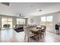 Open concept dining area with adjacent living room at 17452 W Andrea Dr, Surprise, AZ 85387