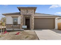 One-story home with stone accents and a two-car garage at 7245 S 75Th Dr, Laveen, AZ 85339
