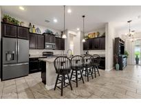 Open kitchen with island and breakfast bar seating at 2126 W Red Fox Rd, Phoenix, AZ 85085
