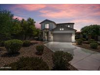 Two-story home with gray exterior, landscaping, and a two-car garage at 8933 W Townley Ave, Peoria, AZ 85345