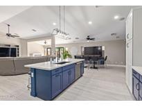 Renovated kitchen with expansive island, stainless appliances, and open floorplan at 17425 W Tara Ln, Surprise, AZ 85388