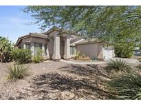 Single-story home with desert landscaping and a two-car garage at 13164 W Ocotillo Ln, Surprise, AZ 85374