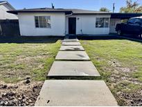 Newly renovated single story home with a landscaped lawn and walkway at 1825 E Amelia Ave, Phoenix, AZ 85016