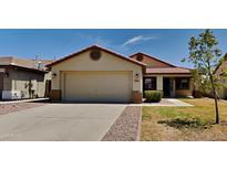 Single-story home with a two-car garage and well-maintained lawn at 30629 N Royal Oak Way, San Tan Valley, AZ 85143