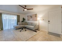 Bright living room with L-shaped sofa, and access to patio at 3500 N Hayden Rd # 1005, Scottsdale, AZ 85251