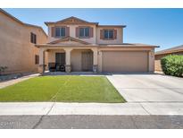 Two-story home with a brown garage door and green lawn at 2343 E Meadow Land Dr, San Tan Valley, AZ 85140