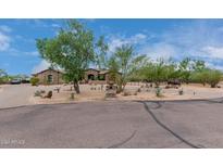 Landscaped front yard with a large tree and stone accents at 35140 N 52Nd Pl, Cave Creek, AZ 85331