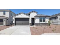 One-story home with a gray garage door, stone accents and landscaping at 6754 W Andrea Dr, Peoria, AZ 85383