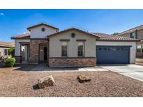 One-story home with a two-car garage and attractive landscaping at 19741 E Reins Rd, Queen Creek, AZ 85142