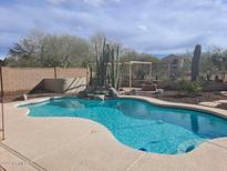 Inviting kidney-shaped pool with desert landscaping at 44973 W Sandhill Rd, Maricopa, AZ 85139