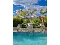 Relaxing pool area with a stone water feature at 18206 W Sells Dr, Goodyear, AZ 85395