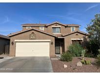 Two story house with tan exterior and landscaping at 20617 N Marina Ave, Maricopa, AZ 85139