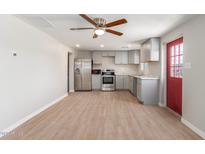 Modern kitchen with stainless steel appliances and light gray cabinets at 9424 N 2Nd Pl, Phoenix, AZ 85020