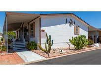 Nice single wide mobile home with covered porch and cacti at 11596 W Sierra Dawn Blvd # 196, Surprise, AZ 85378