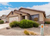 Front view of a house with a two-car garage and neatly landscaped yard at 2420 W Blue Sky Dr, Phoenix, AZ 85085