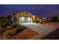 One story home with a two car garage at dusk at 12840 W Santa Ynez Dr, Sun City West, AZ 85375