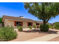 Single story home with mature trees and well-manicured lawn at 2520 E Flower St, Phoenix, AZ 85016