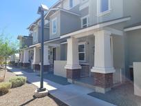 Townhouses with covered porches and attractive landscaping at 639 W Pepper Pl # 107, Mesa, AZ 85201