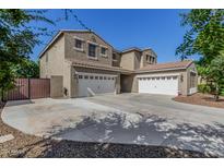 Two-story home with three-car garage and a large, paved driveway at 20144 E Rosa Rd, Queen Creek, AZ 85142