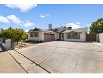 Ranch style home with large driveway and mature trees at 6402 N 45Th Ave, Glendale, AZ 85301