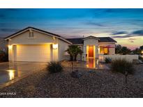 Attractive single-story home with a two-car garage and well-manicured landscaping at 42818 W Morning Dove Ln, Maricopa, AZ 85138