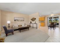 Bright living room with tile floors and view to kitchen at 10816 W Hatcher Rd, Sun City, AZ 85351