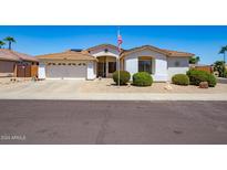 House exterior with landscaping and American flag at 16806 W Halifax St, Surprise, AZ 85374