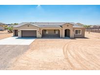 New construction home with a two-car garage and desert landscaping at 115 E Santa Cruz Dr, Phoenix, AZ 85085