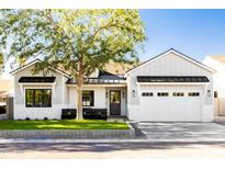 Modern farmhouse style home with white and gray siding, landscaping and a two-car garage at 6836 N 13Th Pl # A, Phoenix, AZ 85014