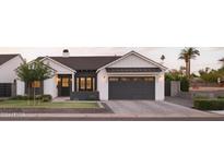 Stunning farmhouse style home with a dark gray garage door at 6836 N 13Th Pl # B, Phoenix, AZ 85014
