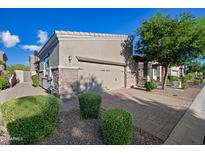 Tan house with two car garage, landscaping and brick driveway at 6202 E Mckellips Rd # 310, Mesa, AZ 85215