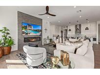 Modern living room with fireplace and large TV at 6166 N Scottsdale Rd # C3006, Paradise Valley, AZ 85253
